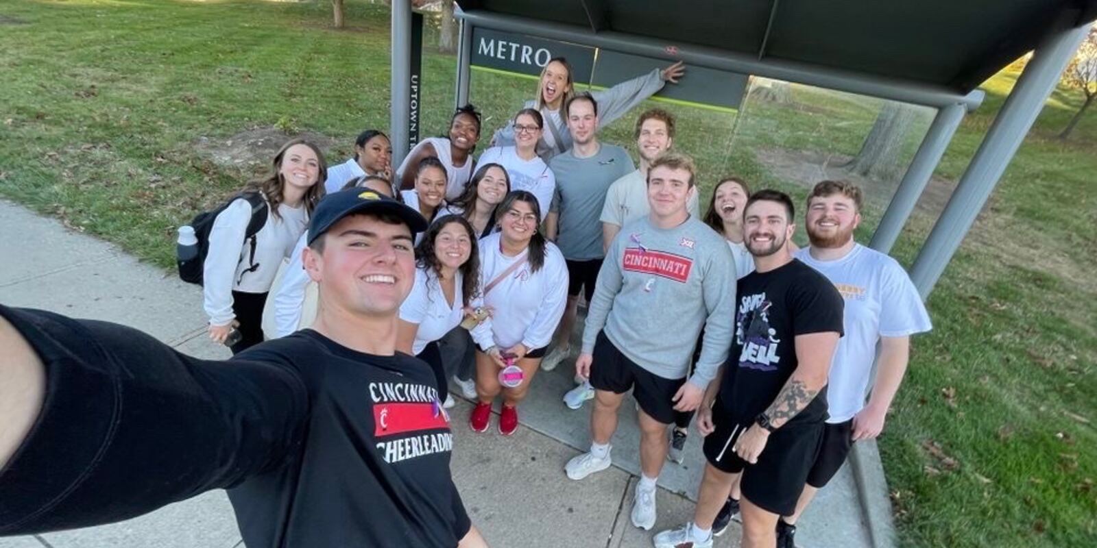University of Cincinnati students gathered near a METRO bus stop